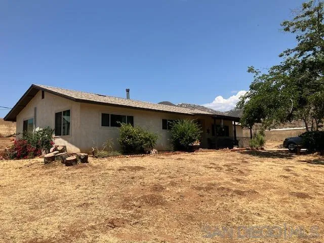 17066 Highway 94 Jamul, CA 91935 - Photo 1 of 23 a view of a house with a yard covered with snow in front of house