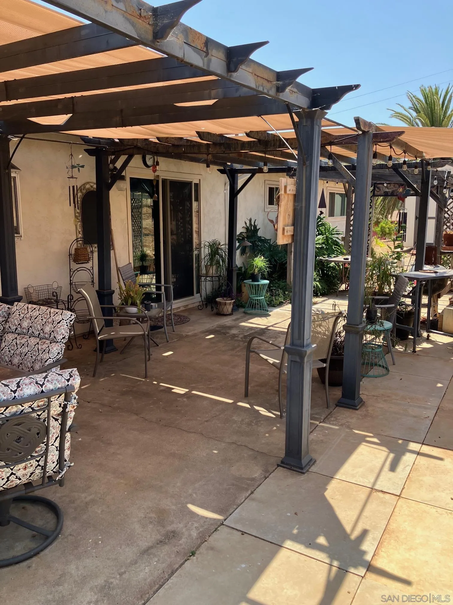 17066 Highway 94 Jamul, CA 91935 - Photo 21 of 23 a view of a patio with table and chairs under an umbrella