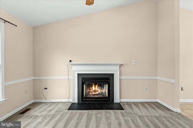 a living room with a fireplace and wooden floor