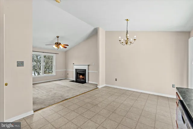 a view of an empty room with a fireplace