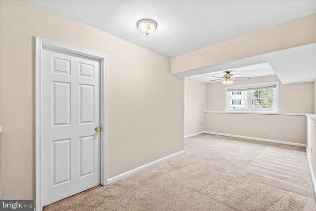 an empty room with windows and cabinet