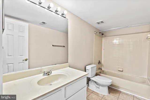 a bathroom with a sink toilet tub and shower