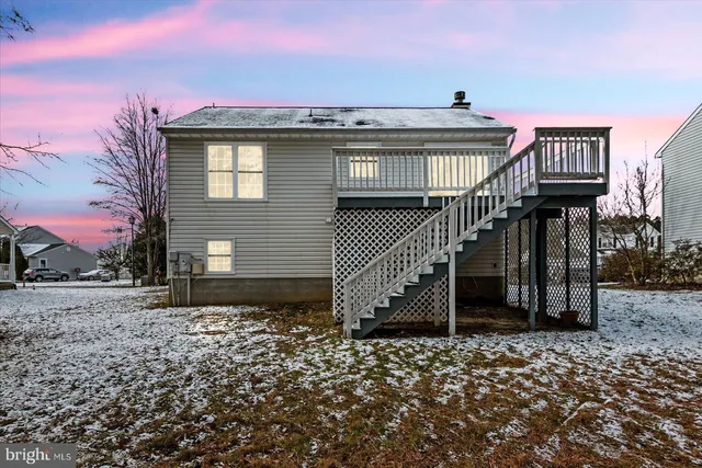 a view of a house with a wooden deck