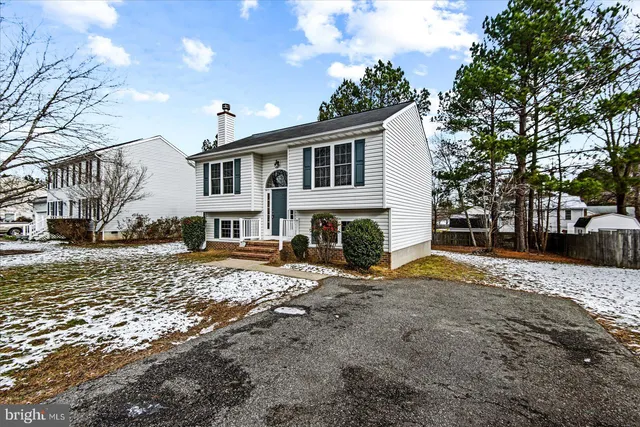 a view of a house with a yard covered in snow