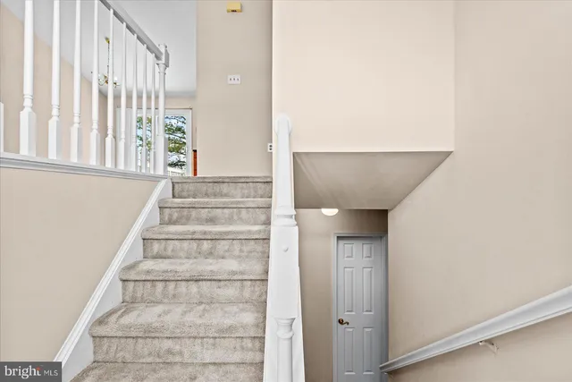 a view of staircase with white walls and windows