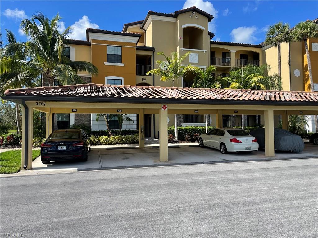 9727 Acqua Court, Unit 421 Naples, FL 34113 - Photo 1 of 26 a view of a car park in front of building