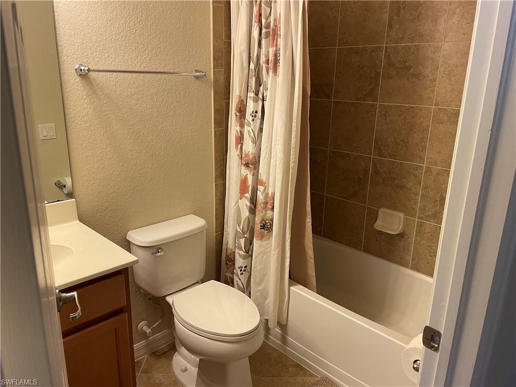 9727 Acqua Court, Unit 421 Naples, FL 34113 - Photo 12 of 26 a bathroom with a toilet and a shower