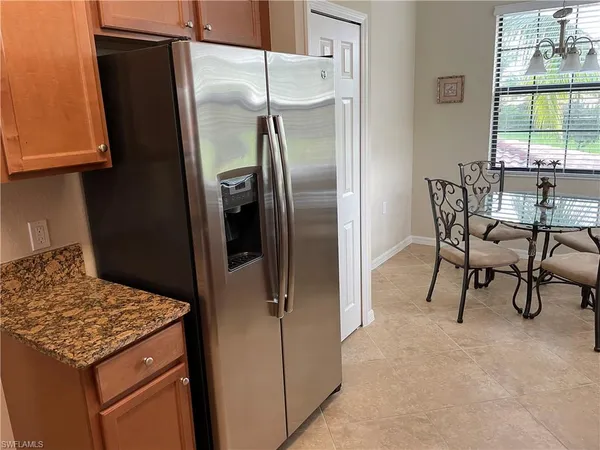 a kitchen with stainless steel appliances granite countertop a refrigerator and a stove