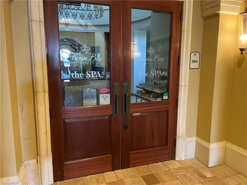 9727 Acqua Court, Unit 421 Naples, FL 34113 - Photo 19 of 26 a bedroom with a bed and wooden floor