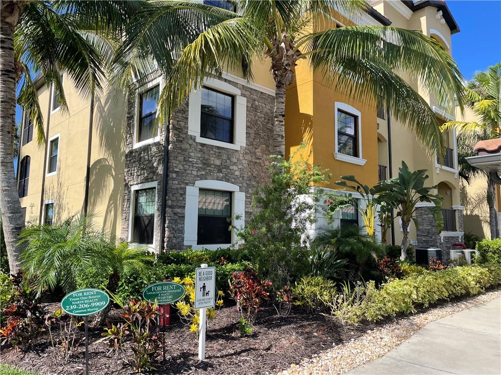 9727 Acqua Court, Unit 421 Naples, FL 34113 - Photo 2 of 26 a view of a house with a yard and front view of a house