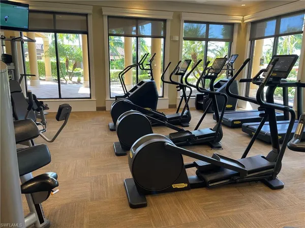 a room with gym equipment and windows