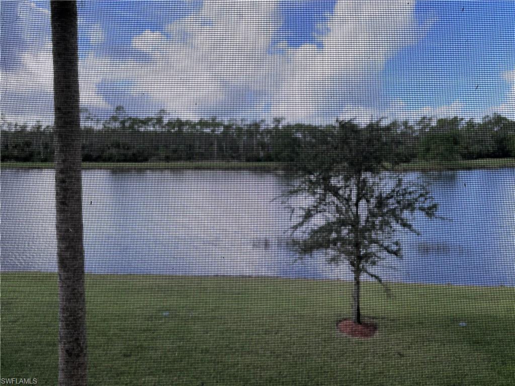 9727 Acqua Court, Unit 421 Naples, FL 34113 - Photo 3 of 26 a view of lake with green space