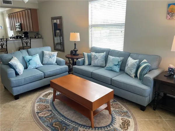 a living room with furniture and a rug