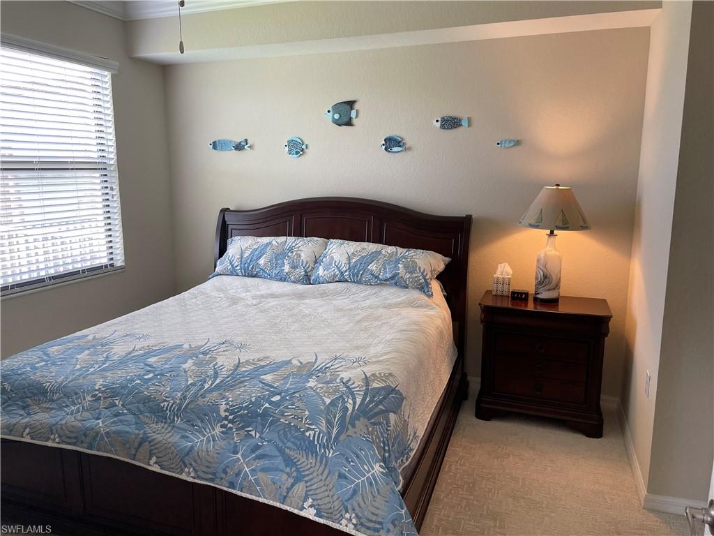 9727 Acqua Court, Unit 421 Naples, FL 34113 - Photo 8 of 26 a bedroom with a bed and a window