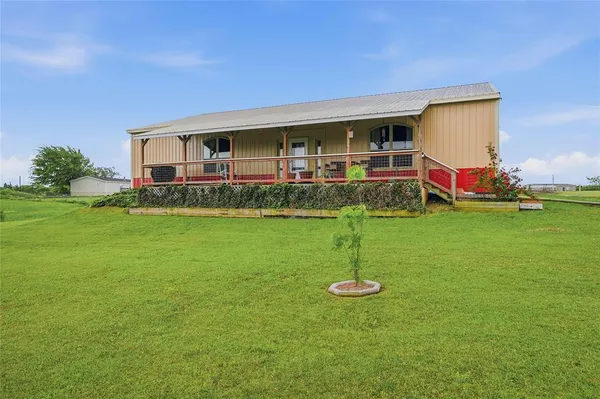 a view of a house with a yard porch and sitting area