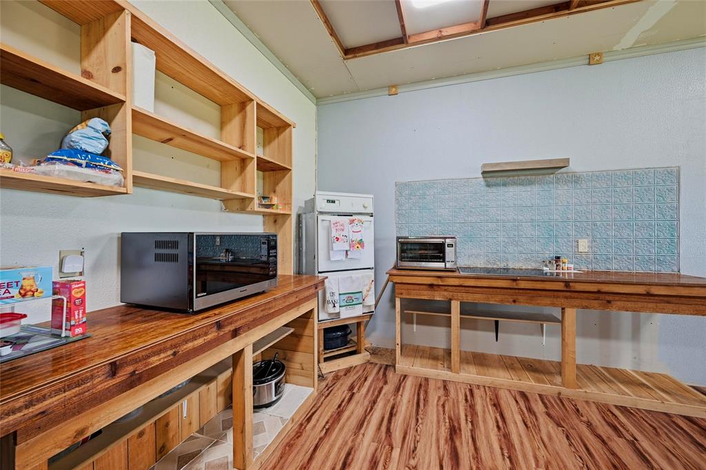1464 Keyes Road Sherman, TX 75092 - Photo 14 of 29 a kitchen with stainless steel appliances a stove and more cabinets