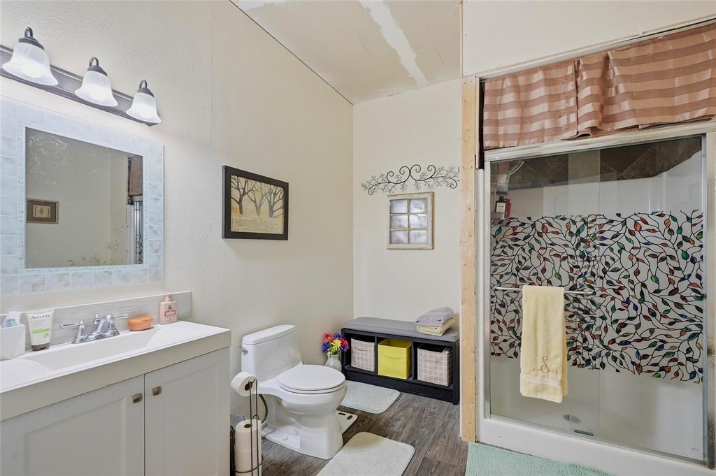 1464 Keyes Road Sherman, TX 75092 - Photo 17 of 29 a bathroom with a toilet a sink and mirror
