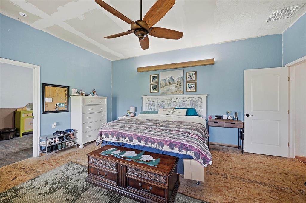 1464 Keyes Road Sherman, TX 75092 - Photo 21 of 29 a bedroom with a bed a dresser and a chandelier