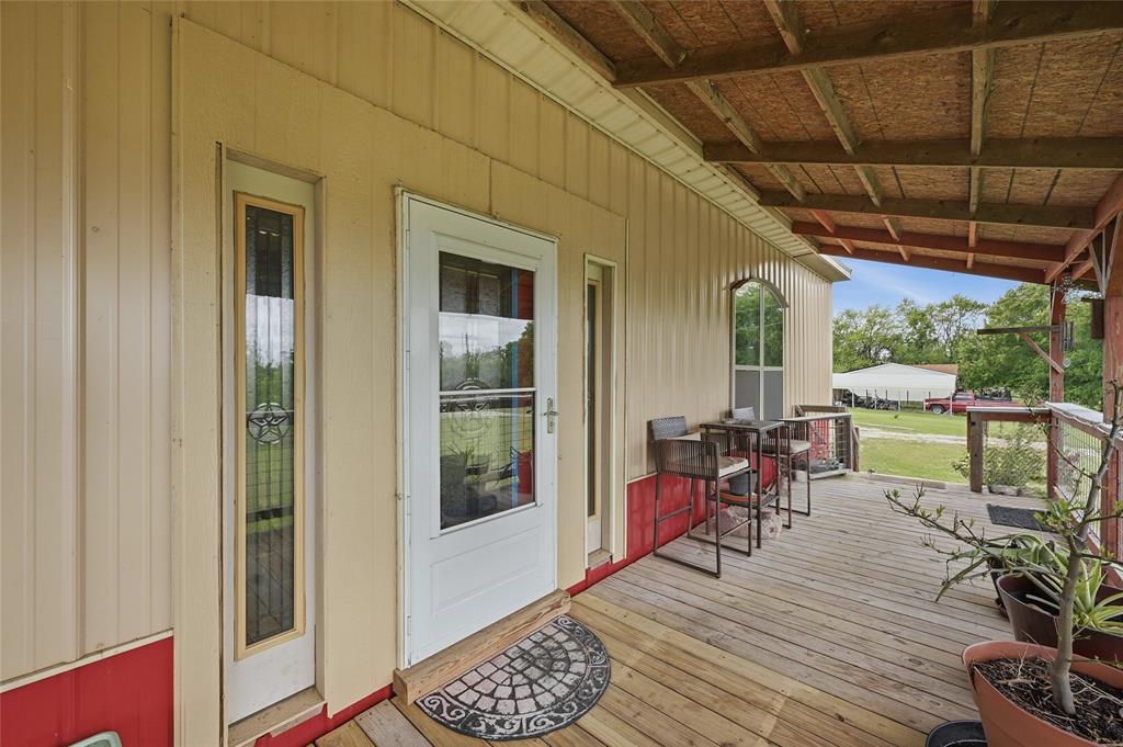 1464 Keyes Road Sherman, TX 75092 - Photo 4 of 29 a view of a patio with wooden floor a yard table and chairs