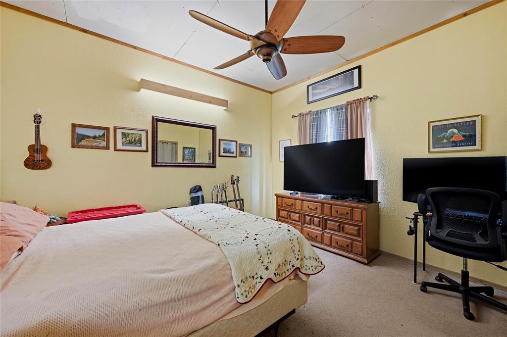 1464 Keyes Road Sherman, TX 75092 - Photo 5 of 29 a bedroom with a bed and a flat screen tv