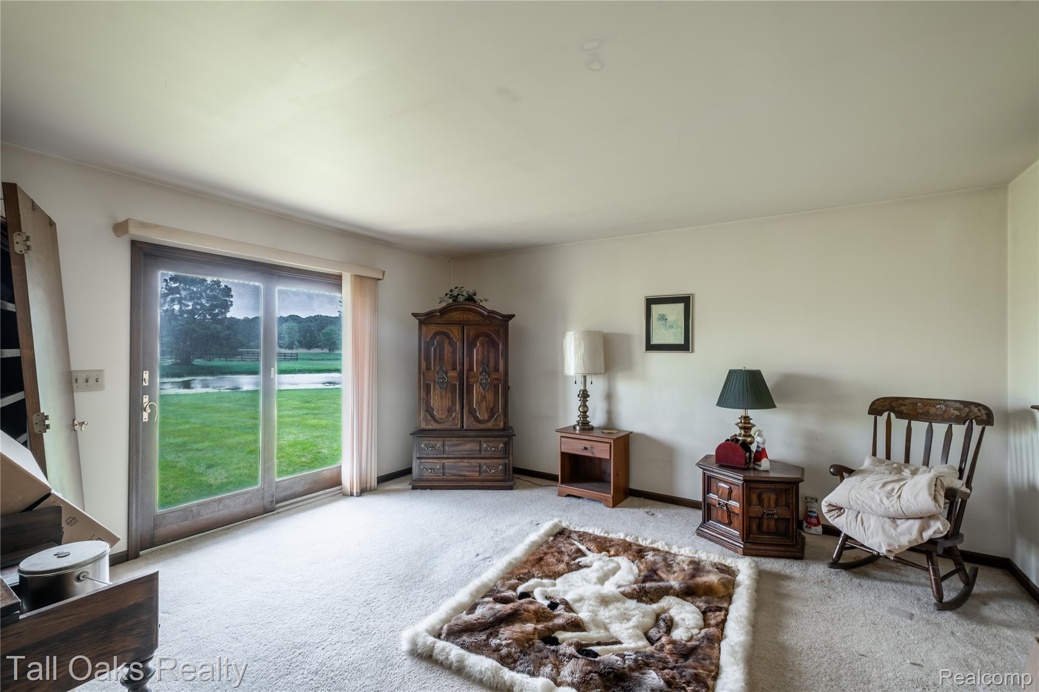79330 Capac Road Armada, MI 48005 - Photo 31 of 42 Bright interior space featuring a glass sliding door, carpet flooring, and white walls