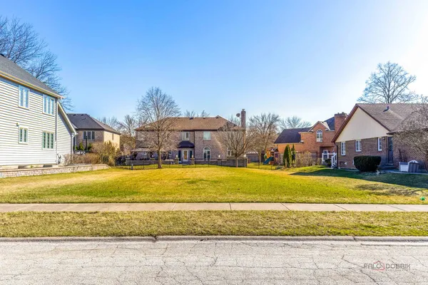 a view of a large house with a swimming pool and a yard