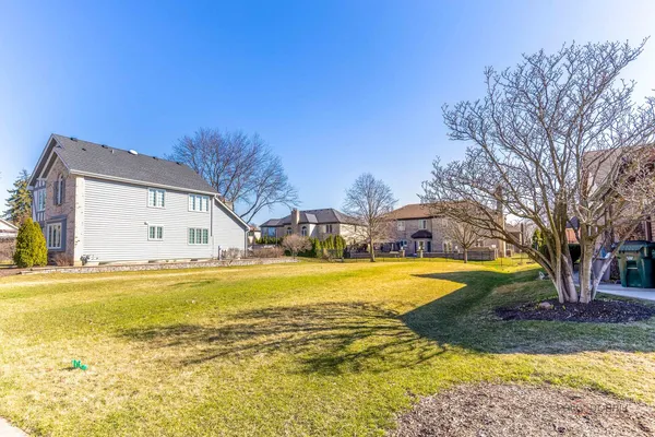 a view of a house with pool and a yard