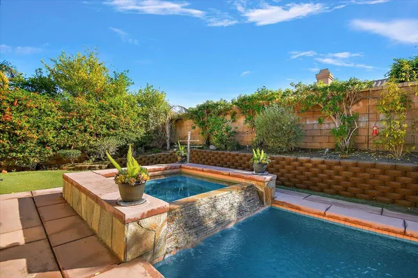 a view of a backyard with swimming pool