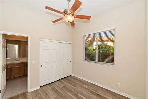 a view of a livingroom with a ceiling fan and wooden floor