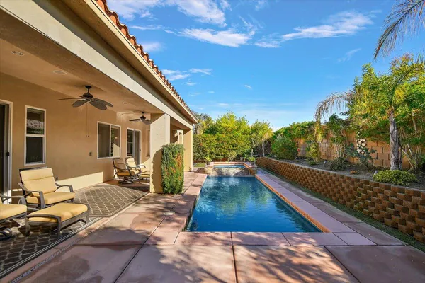a view of swimming pool with chairs