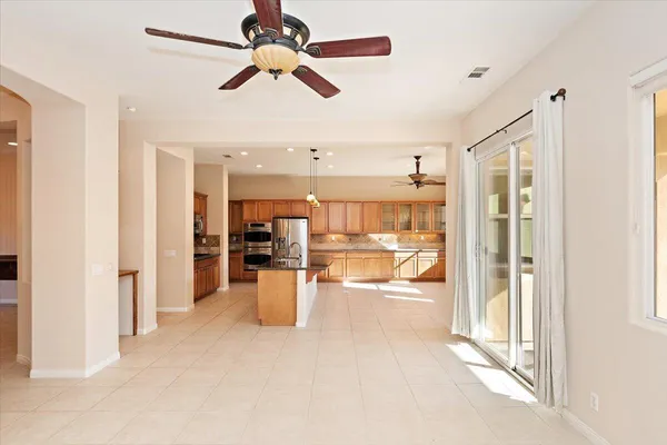a view of a living room and chandelier fan