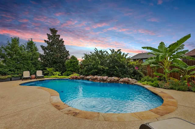 a view of a swimming pool with a yard