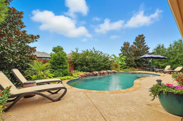 a view of backyard with outdoor seating and plants