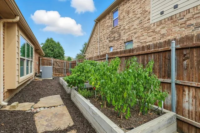 a view of a patio with table and chairs and potted plants