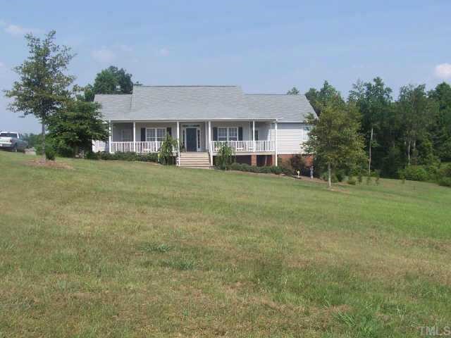 777 Chisenhall Road Angier, NC 27501 - Photo 1 of 1 a front view of a house with a garden and trees