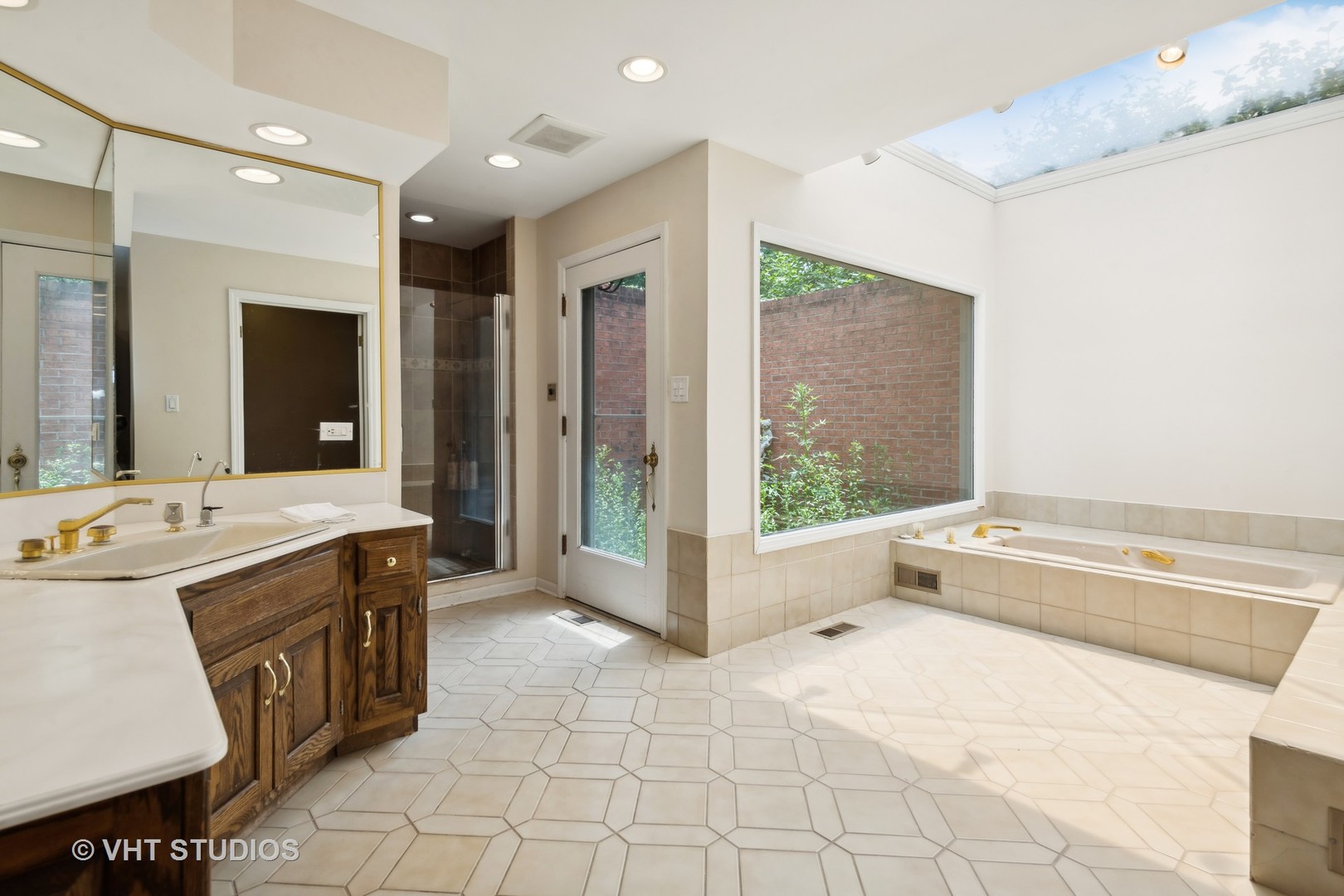 1766 Firth Road Inverness, IL 60067 - Photo 27 of 53 a spacious bathroom with a tub sink and mirror