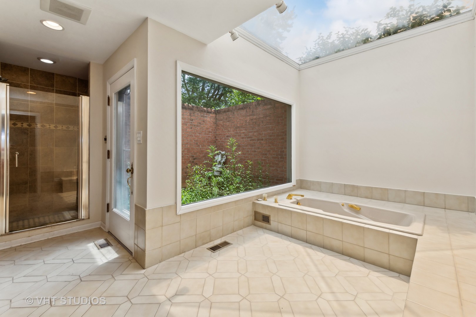 1766 Firth Road Inverness, IL 60067 - Photo 28 of 53 a spacious bathroom with a tub a mirror and a shower