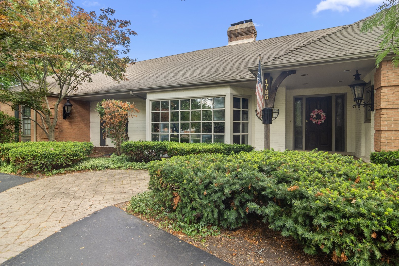 1766 Firth Road Inverness, IL 60067 - Photo 4 of 53 front view of a brick house with potted plants