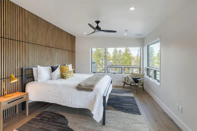 a bedroom with a bed and a large window