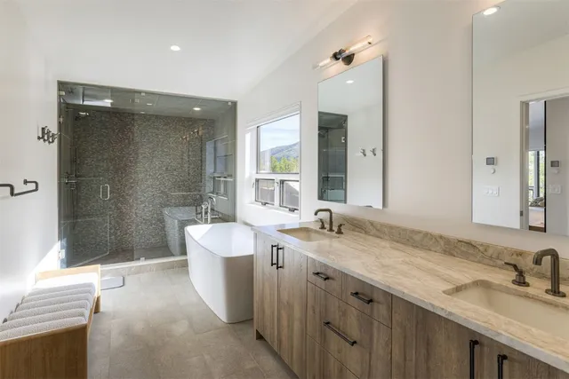 a spacious bathroom with a granite countertop sink mirror and a