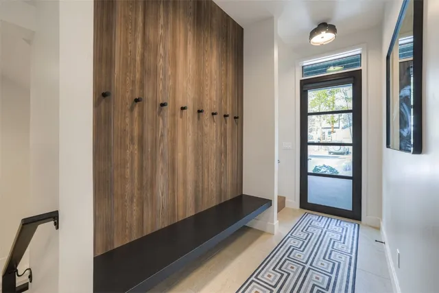 a view of a closet area with wooden floor