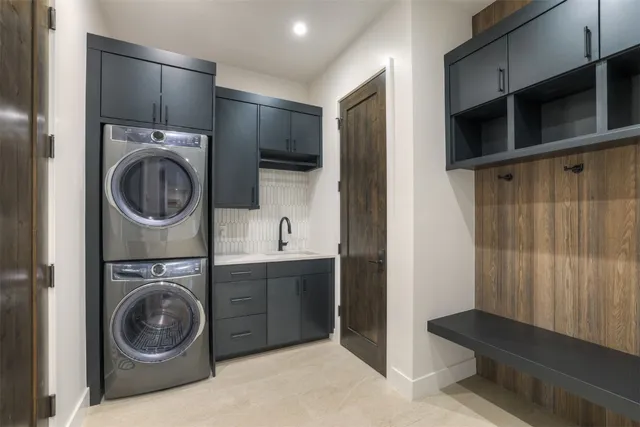 a utility room with sink dryer and washer