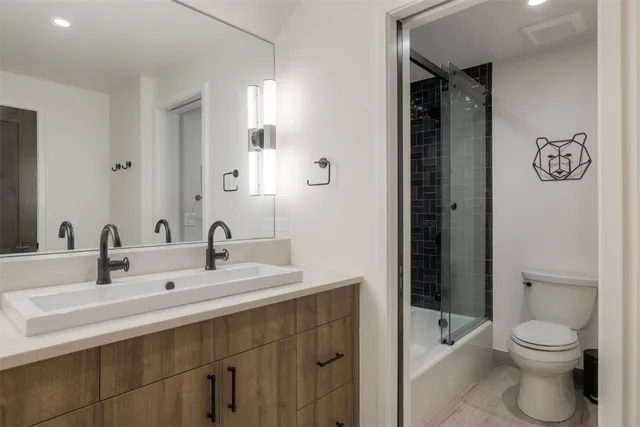 a bathroom with a toilet a sink and mirror