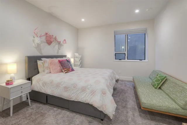 a bedroom with a bed and a couch