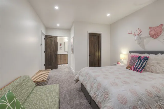 a bedroom with a large bed and a couch