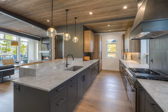 a kitchen with sink stove and refrigerator