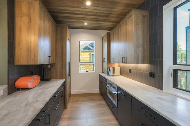 a bathroom with a granite countertop sink and a large mirror