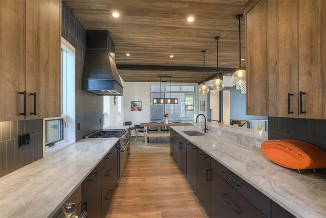 a large kitchen with lots of counter space and a sink