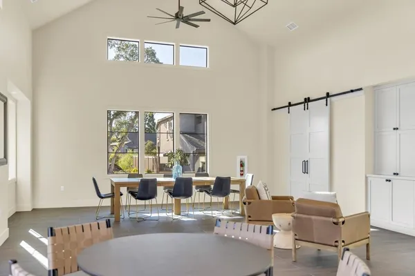 a dining room with furniture a chandelier and wooden floor