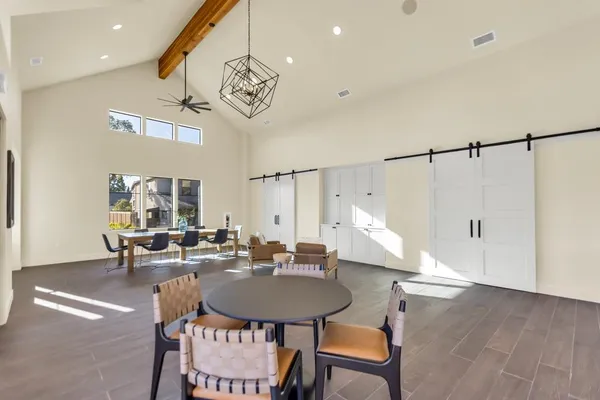 a living room with furniture and a chandelier